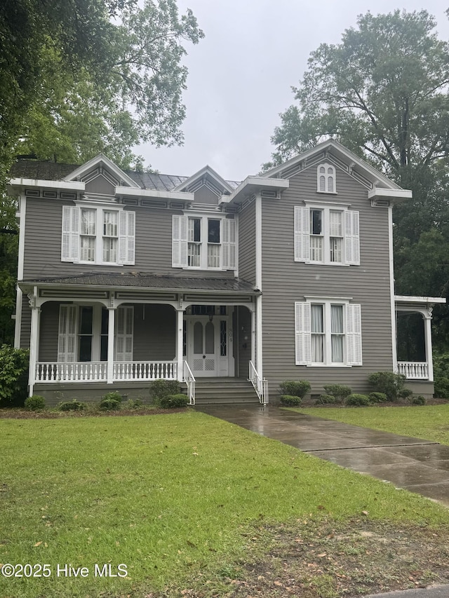 view of front of house with a porch and a front yard