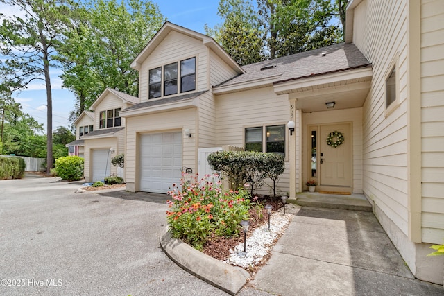 935 Birch Creek Dr, Wilmington, NC 28403 - view of front facade featuring asphalt driveway, a garage, and roof with shingles