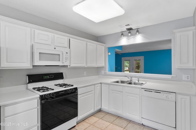 935 Birch Creek Dr, Wilmington, NC 28403 - kitchen featuring white appliances, white cabinetry, light tile patterned floors, and light countertops