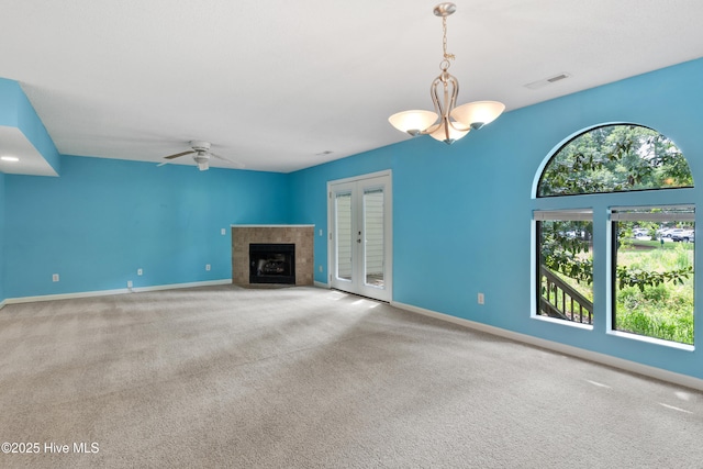 935 Birch Creek Dr, Wilmington, NC 28403 - unfurnished living room with carpet, a ceiling fan, a tile fireplace, and french doors