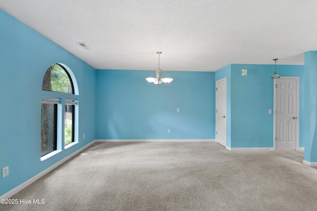 935 Birch Creek Dr, Wilmington, NC 28403 - spare room featuring carpet, a chandelier, and a textured ceiling