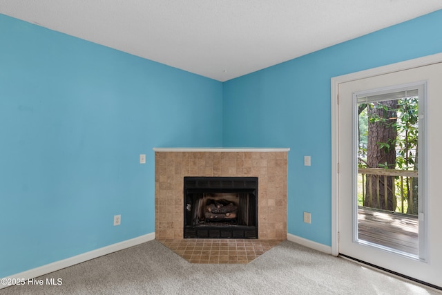 935 Birch Creek Dr, Wilmington, NC 28403 - unfurnished living room with a tiled fireplace and carpet flooring