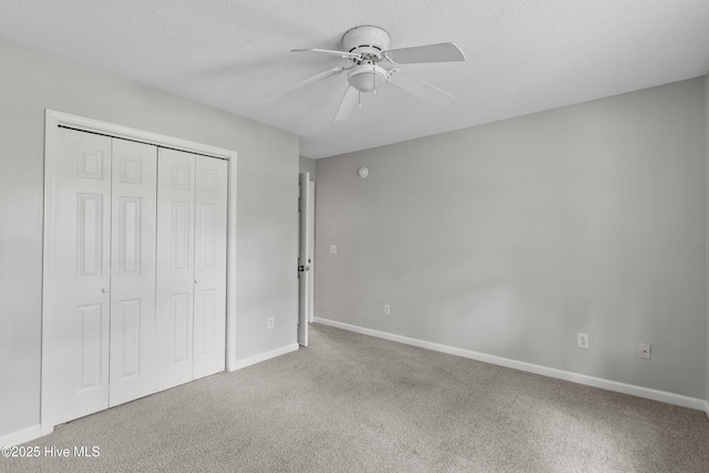 935 Birch Creek Dr, Wilmington, NC 28403 - unfurnished bedroom featuring carpet, a closet, a ceiling fan, and a textured ceiling