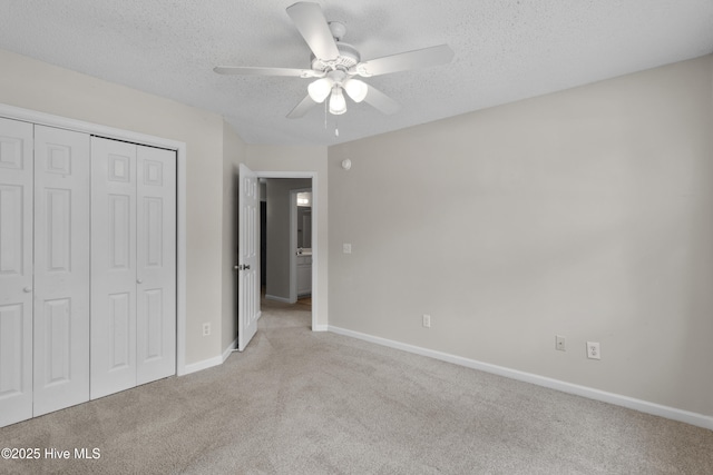 935 Birch Creek Dr, Wilmington, NC 28403 - unfurnished bedroom with carpet floors, a textured ceiling, a closet, and a ceiling fan
