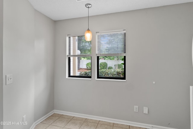 935 Birch Creek Dr, Wilmington, NC 28403 - empty room with light tile patterned floors and a textured ceiling