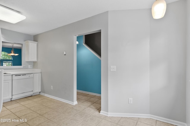 935 Birch Creek Dr, Wilmington, NC 28403 - kitchen featuring white dishwasher, light countertops, white cabinets, light tile patterned floors, and a chandelier