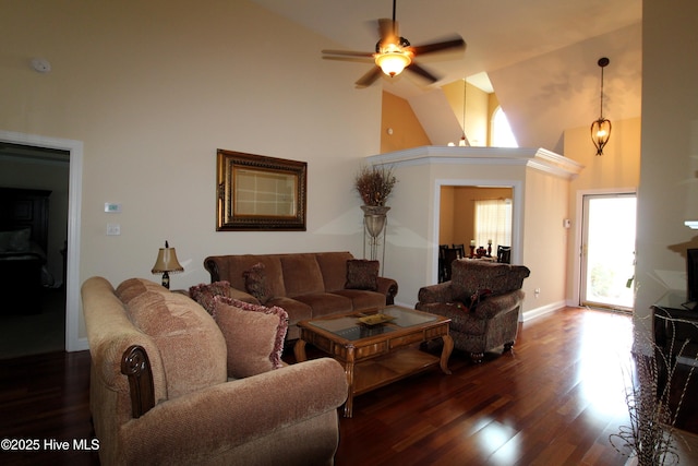 living area with high vaulted ceiling, wood finished floors, ceiling fan, and baseboards