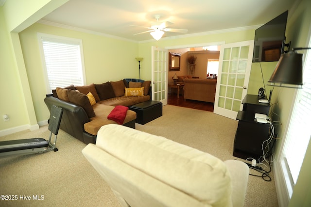 carpeted living room with french doors, ornamental molding, ceiling fan, and baseboards