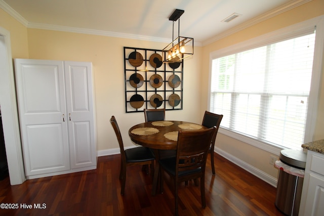 dining space with dark wood-style floors, baseboards, crown molding, and a chandelier