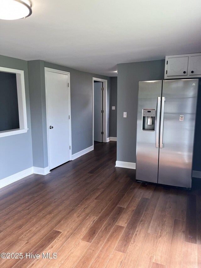 527 Chicora St, Grimesland, NC 27837 - kitchen featuring stainless steel fridge, dark wood-type flooring, baseboards, and white cabinets