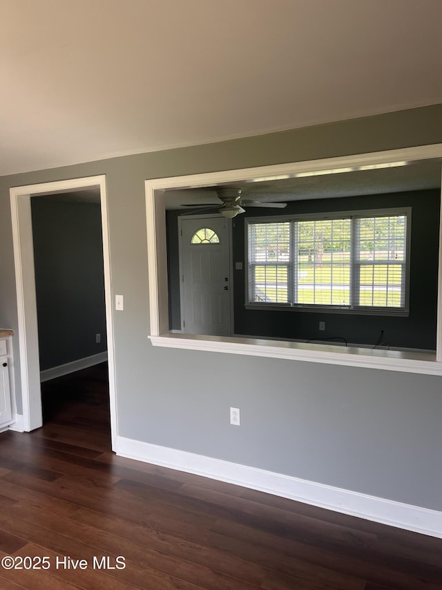 527 Chicora St, Grimesland, NC 27837 - spare room with dark wood-style floors, a ceiling fan, and baseboards
