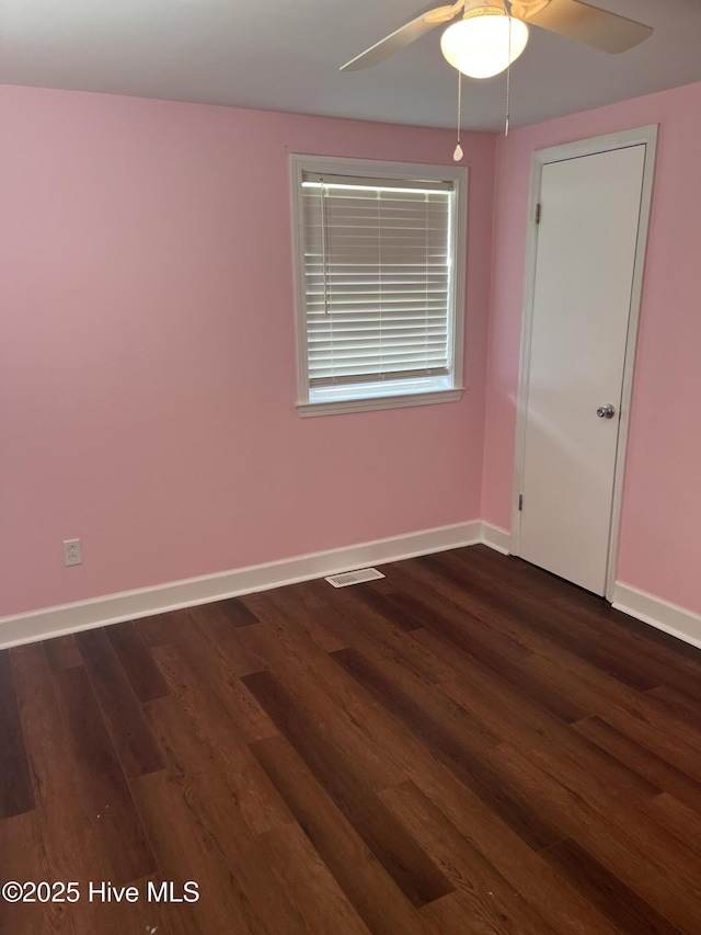 527 Chicora St, Grimesland, NC 27837 - empty room featuring ceiling fan, dark wood-type flooring, and baseboards
