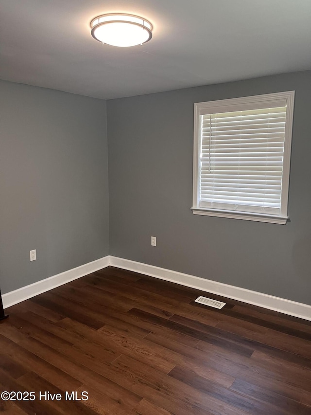 527 Chicora St, Grimesland, NC 27837 - unfurnished room with baseboards and dark wood-style flooring