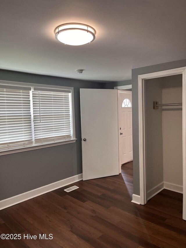 527 Chicora St, Grimesland, NC 27837 - unfurnished bedroom featuring baseboards, wood finished floors, and a closet