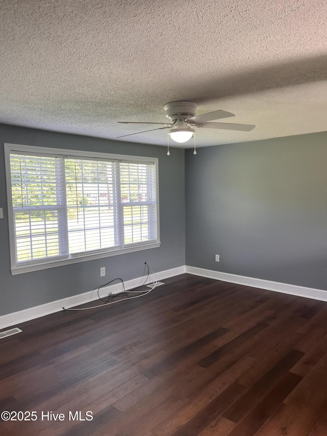 527 Chicora St, Grimesland, NC 27837 - empty room with a textured ceiling, a ceiling fan, dark wood-style flooring, and baseboards
