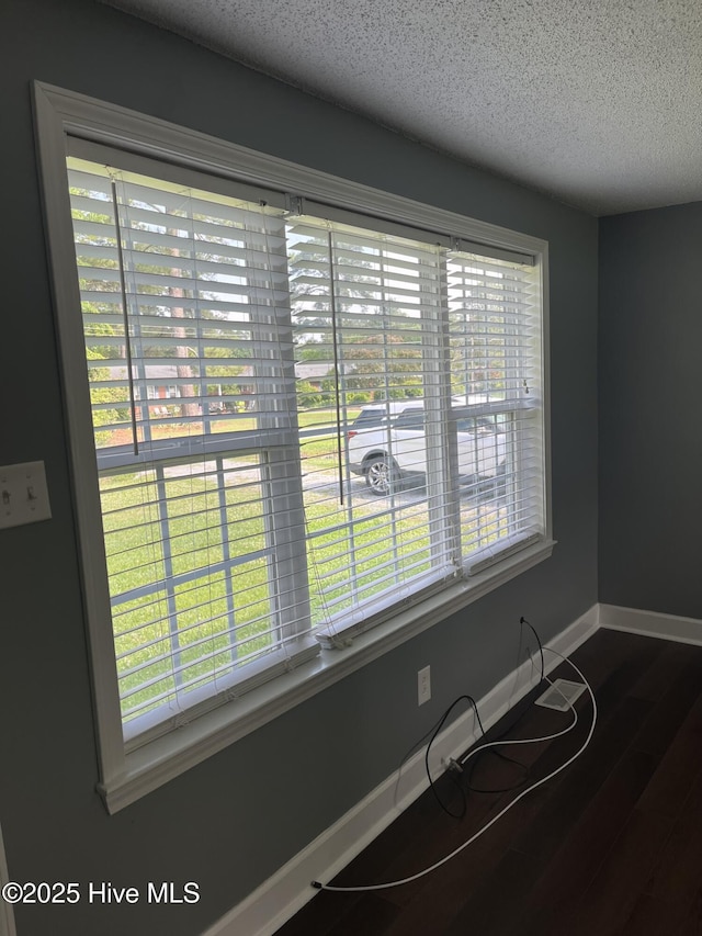 527 Chicora St, Grimesland, NC 27837 - detailed view of a textured ceiling, wood finished floors, and baseboards