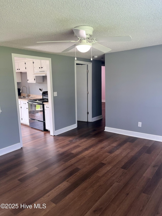 527 Chicora St, Grimesland, NC 27837 - unfurnished living room with a sink, a textured ceiling, dark wood-style flooring, and baseboards