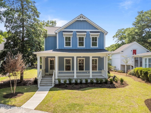 9213 Rivendell Pl SW, Calabash, NC 28467 - view of front of house featuring board and batten siding, a shingled roof, a porch, and a front yard