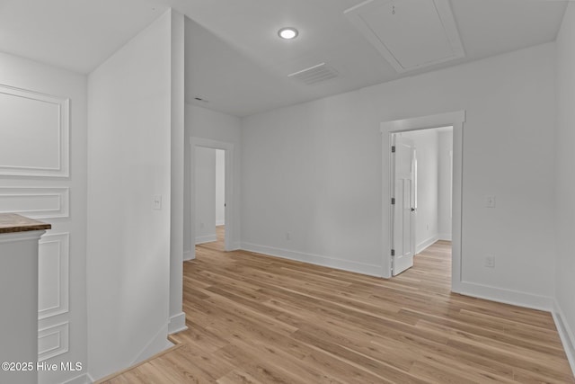 9213 Rivendell Pl SW, Calabash, NC 28467 - spare room with baseboards, light wood finished floors, attic access, and recessed lighting