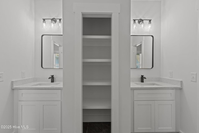 9213 Rivendell Pl SW, Calabash, NC 28467 - full bathroom with built in shelves, two vanities, and a walk in closet