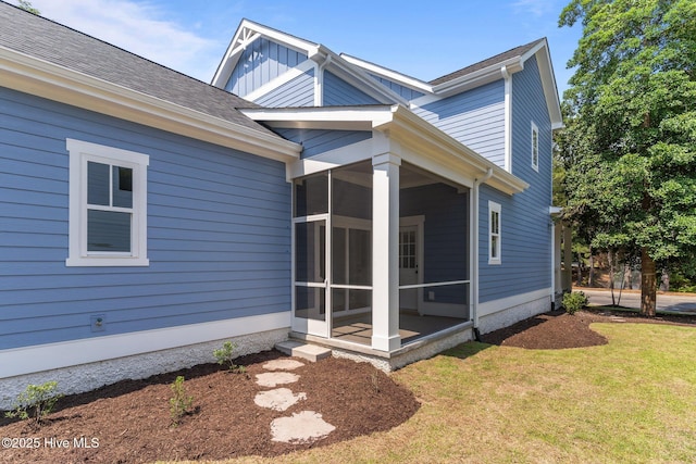 9213 Rivendell Pl SW, Calabash, NC 28467 - back of house featuring a sunroom, a yard, and board and batten siding