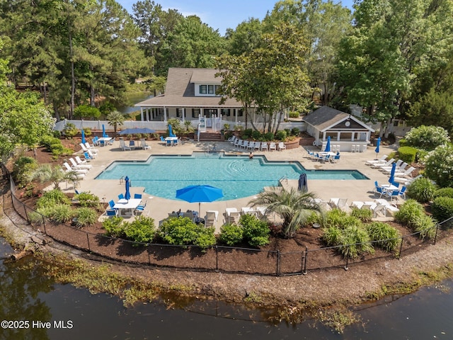 9213 Rivendell Pl SW, Calabash, NC 28467 - community pool with a patio area, a water view, and view of scattered trees