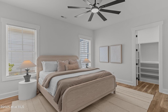 9213 Rivendell Pl SW, Calabash, NC 28467 - bedroom with baseboards, wood finished floors, a spacious closet, and ceiling fan