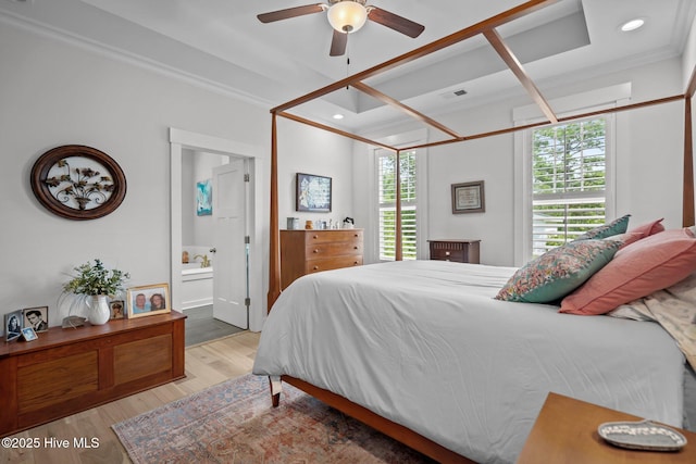 bedroom featuring light wood-style flooring, ornamental molding, ensuite bathroom, recessed lighting, and a ceiling fan