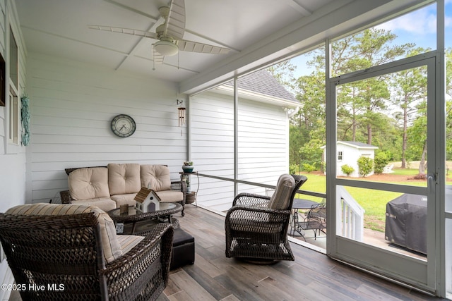 sunroom with outdoor lounge area and a ceiling fan