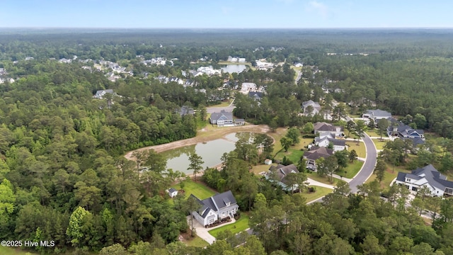aerial overview of property's location with a heavily wooded area, a nearby body of water, and nearby suburban area