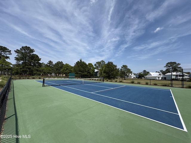 view of tennis court with fence and community basketball court
