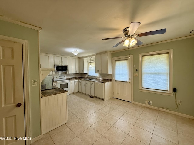 208 W Gray St, Windsor, NC 27983 - kitchen featuring white appliances, dark countertops, a sink, light tile patterned floors, and ornamental molding