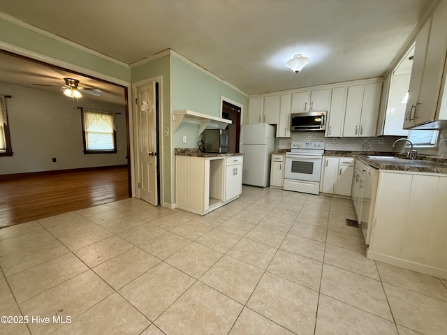 208 W Gray St, Windsor, NC 27983 - kitchen featuring white appliances, dark countertops, crown molding, light tile patterned floors, and tasteful backsplash