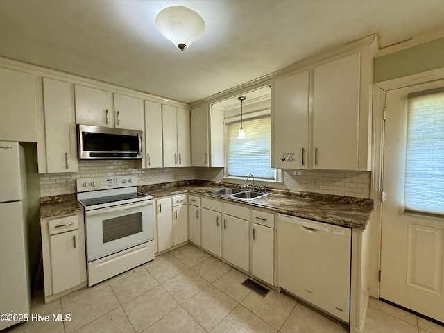 208 W Gray St, Windsor, NC 27983 - kitchen featuring white appliances, a sink, dark countertops, and decorative backsplash