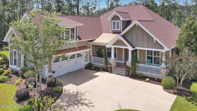 1013 Dowling Ct, Leland, NC 28451 - craftsman-style house featuring board and batten siding, driveway, a porch, and an attached garage