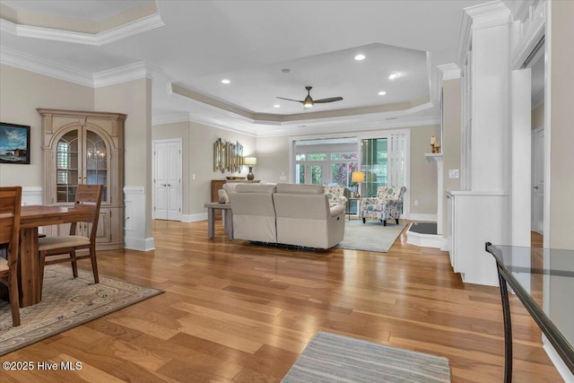 1013 Dowling Ct, Leland, NC 28451 - living area featuring a raised ceiling, a ceiling fan, light wood-style flooring, crown molding, and recessed lighting