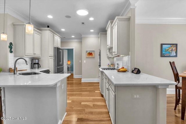 1013 Dowling Ct, Leland, NC 28451 - kitchen with a sink, ornamental molding, a peninsula, baseboards, and high end refrigerator