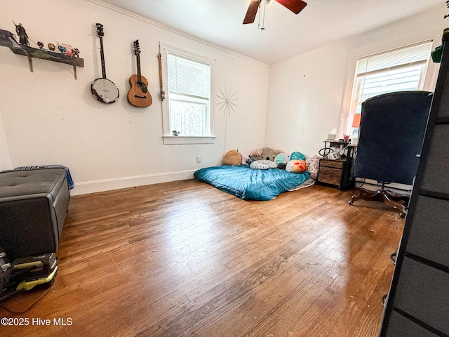 1605 E Holly St, Goldsboro, NC 27530 - bedroom featuring multiple windows, wood finished floors, ornamental molding, and a ceiling fan