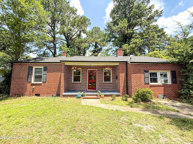1605 E Holly St, Goldsboro, NC 27530 - ranch-style house with brick siding, a front yard, a chimney, french doors, and cooling unit