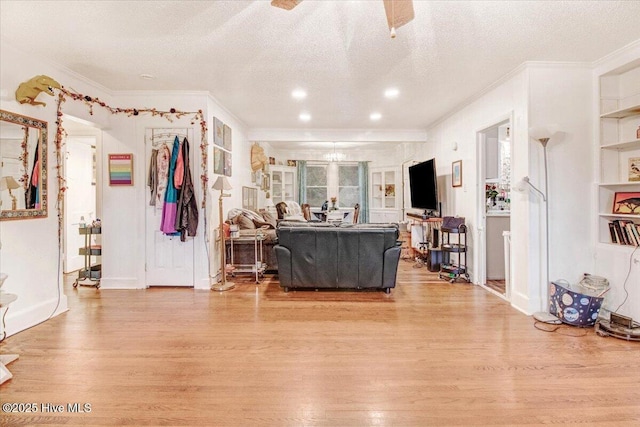 1605 E Holly St, Goldsboro, NC 27530 - living area with crown molding, light wood-style floors, a textured ceiling, and ceiling fan
