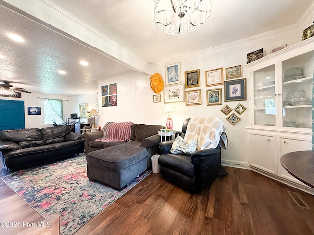 1605 E Holly St, Goldsboro, NC 27530 - living area with dark wood finished floors, a chandelier, crown molding, a textured ceiling, and ceiling fan