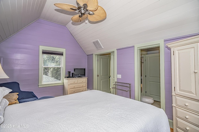659 Wash Woods Way, Bald Head Island, NC 28461 - bedroom with lofted ceiling, ensuite bathroom, wood walls, and a ceiling fan