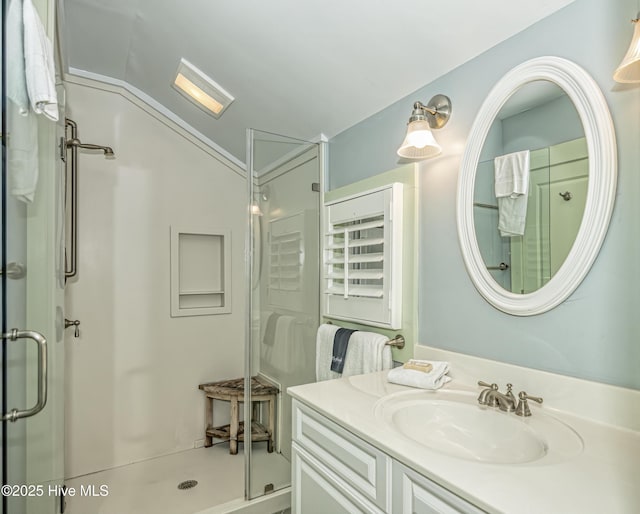 659 Wash Woods Way, Bald Head Island, NC 28461 - bathroom with a stall shower, vaulted ceiling, and vanity
