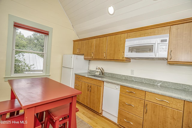 659 Wash Woods Way, Bald Head Island, NC 28461 - kitchen featuring white appliances, vaulted ceiling, a sink, light wood-style flooring, and light countertops
