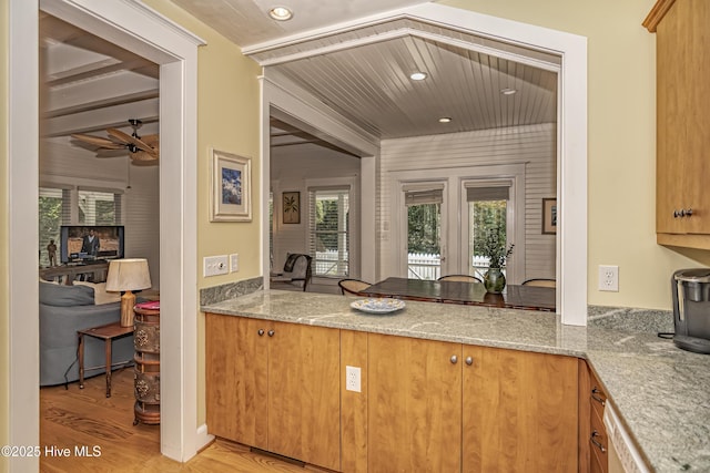659 Wash Woods Way, Bald Head Island, NC 28461 - kitchen with healthy amount of natural light, light wood-style flooring, a ceiling fan, light stone counters, and recessed lighting
