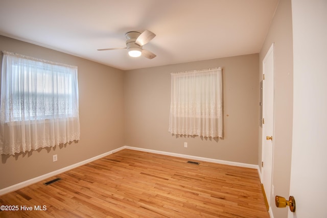 unfurnished room featuring light wood-type flooring, baseboards, and ceiling fan