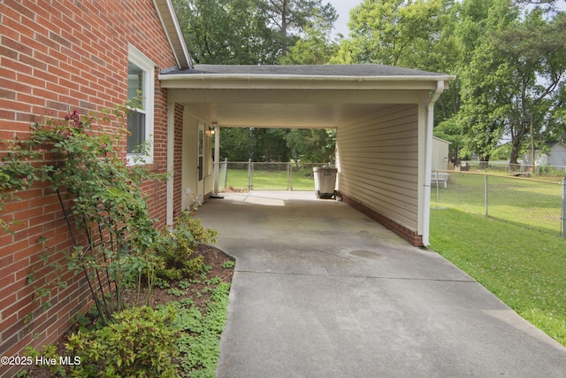 view of parking / parking lot with concrete driveway and an attached carport