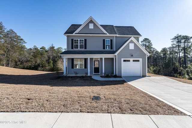 traditional-style house featuring concrete driveway and covered porch