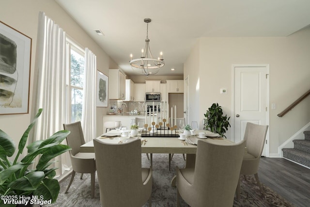 dining space featuring a chandelier, stairway, dark wood finished floors, and baseboards