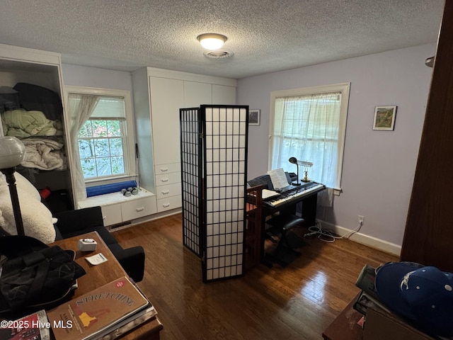 office with wood finished floors, a textured ceiling, and baseboards
